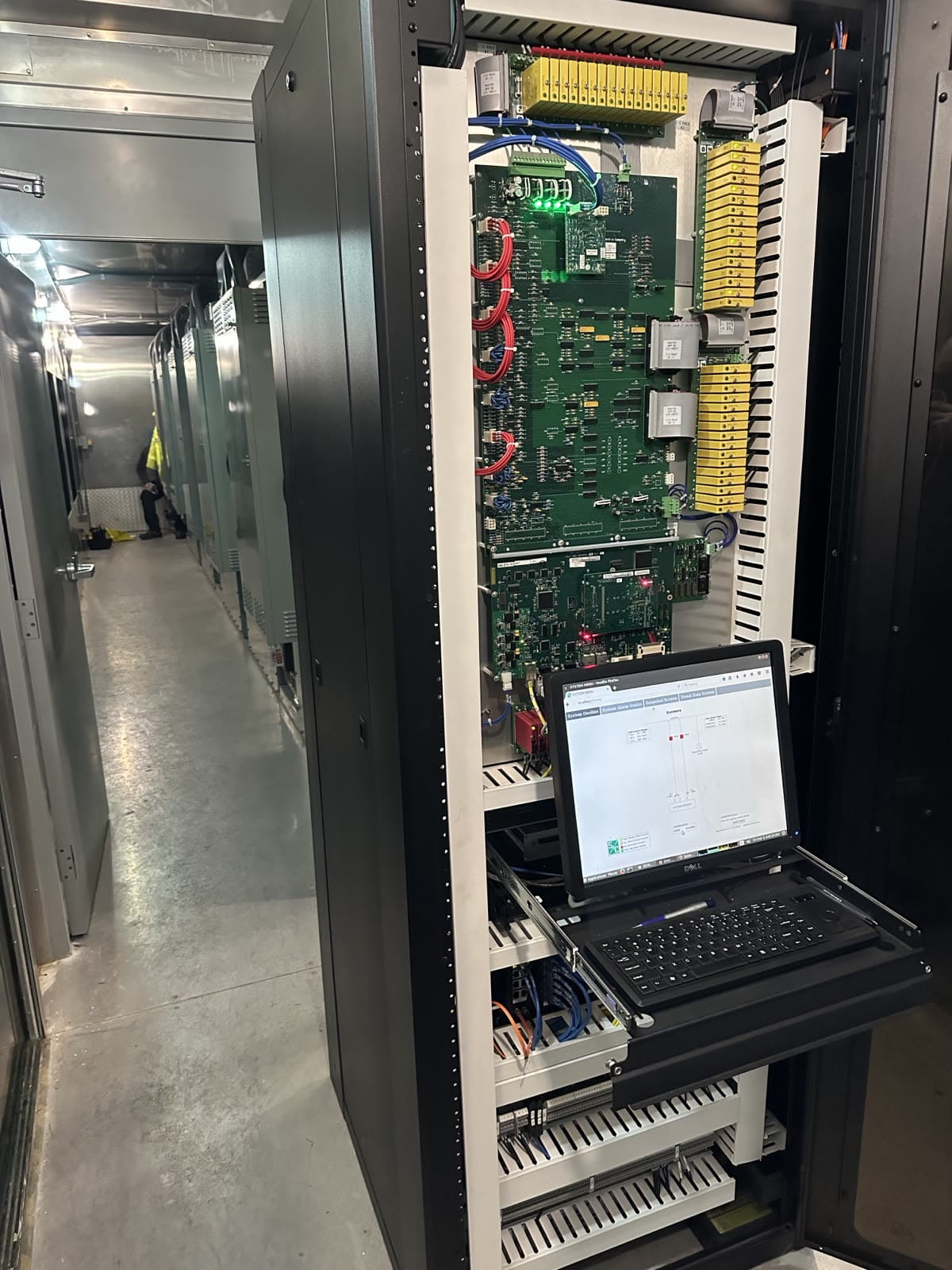 Control cabinet opened for commissioning with a laptop connected